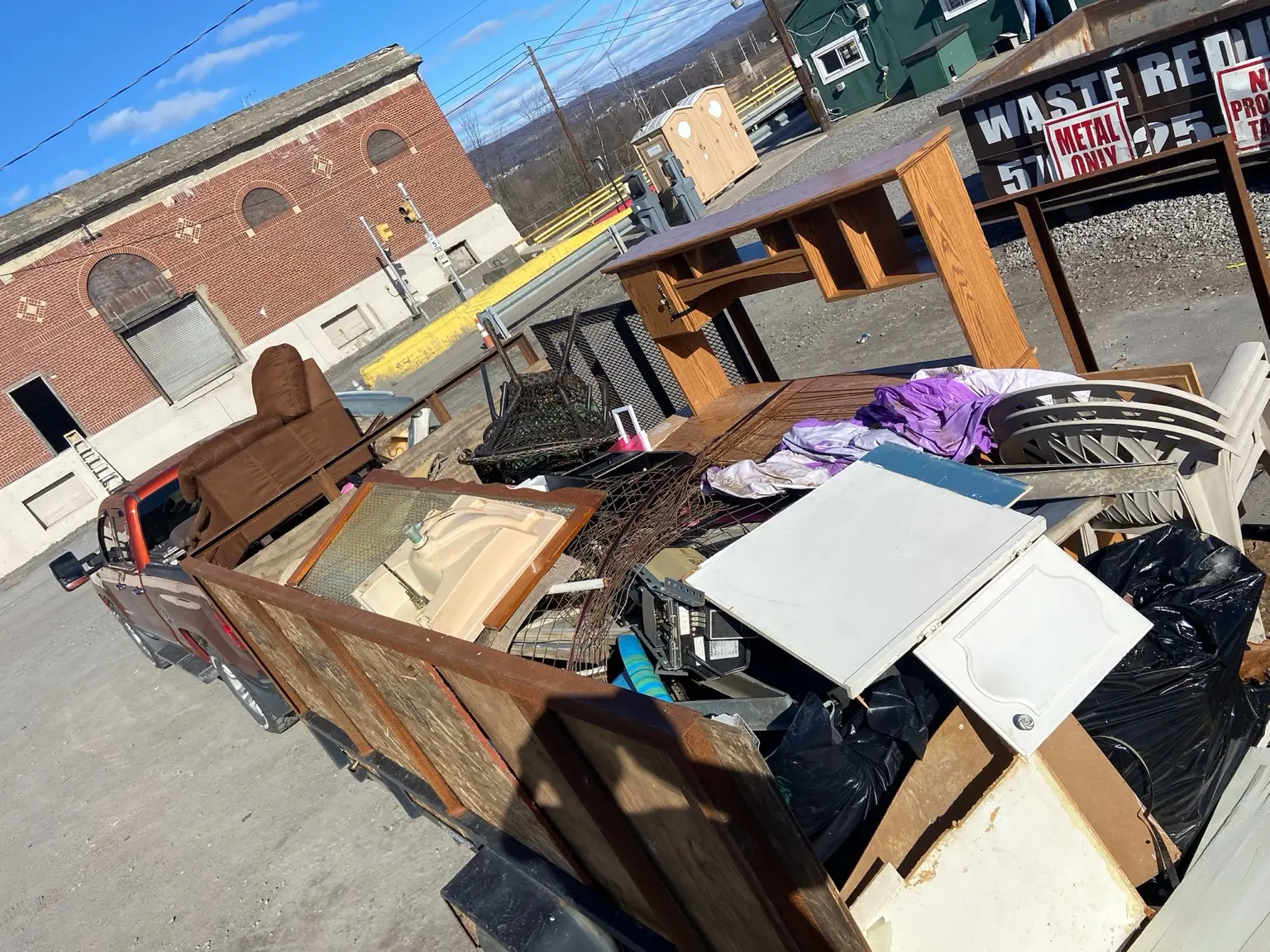 Mixed furniture and household junk loaded for removal