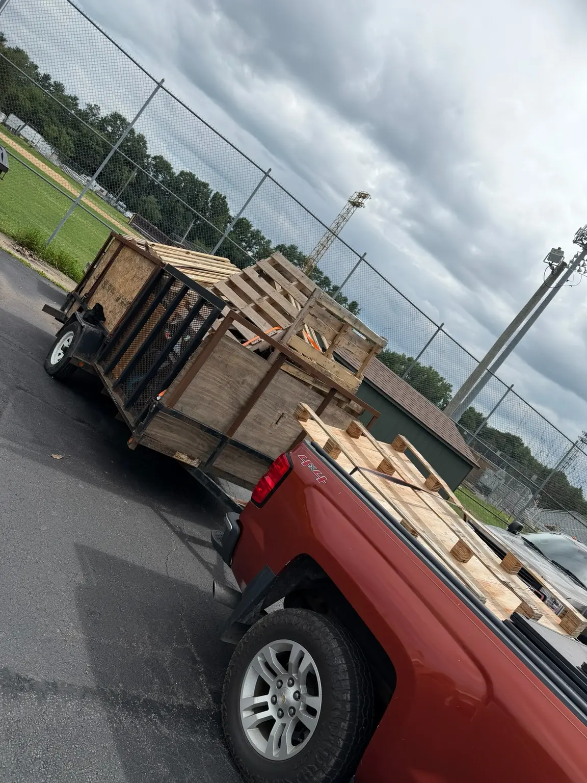 Truck and trailer loaded with commercial wood pallets
