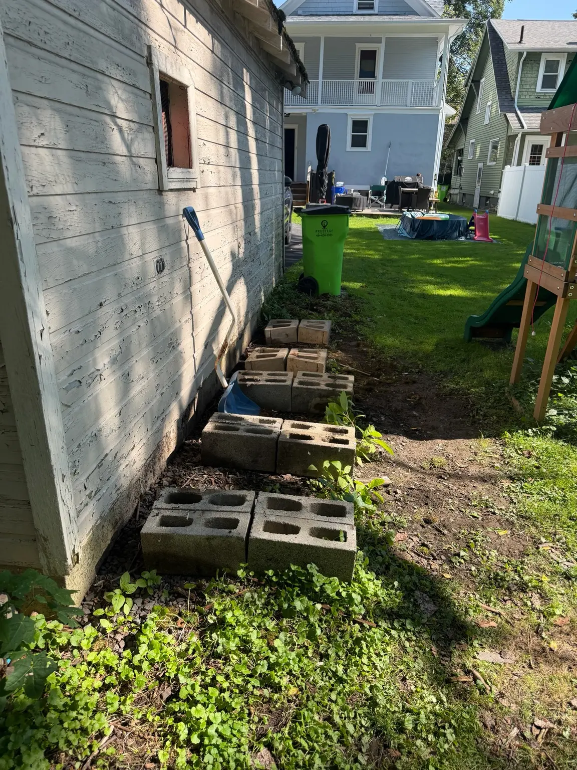 Cleared area beside the garage after flooring debris removal
