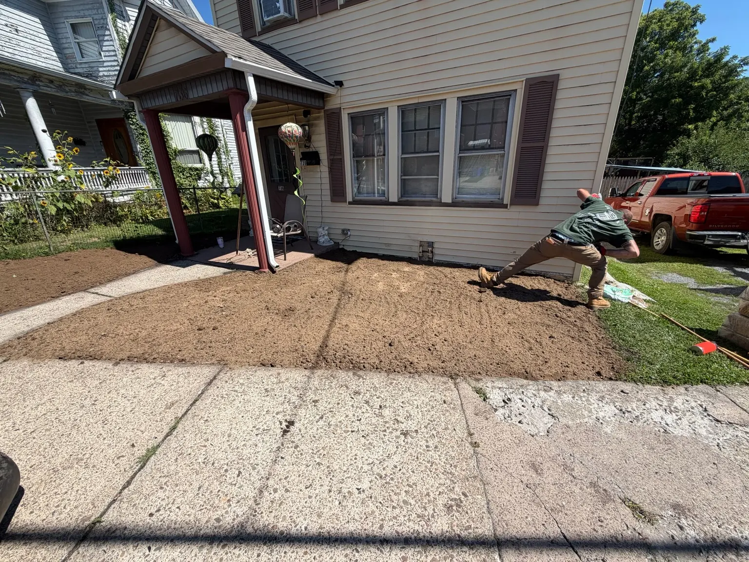 Fresh dirt being spread across the cleared front yard