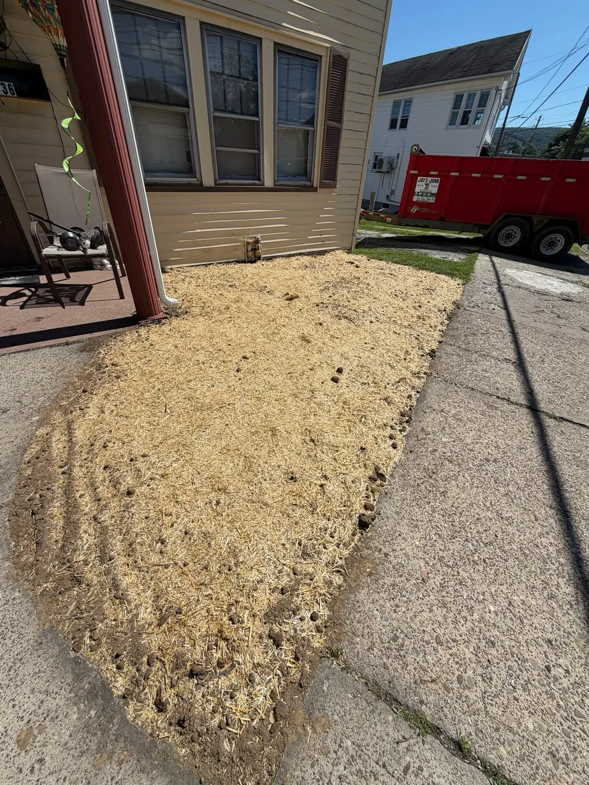 Freshly seeded front yard covered with protective straw