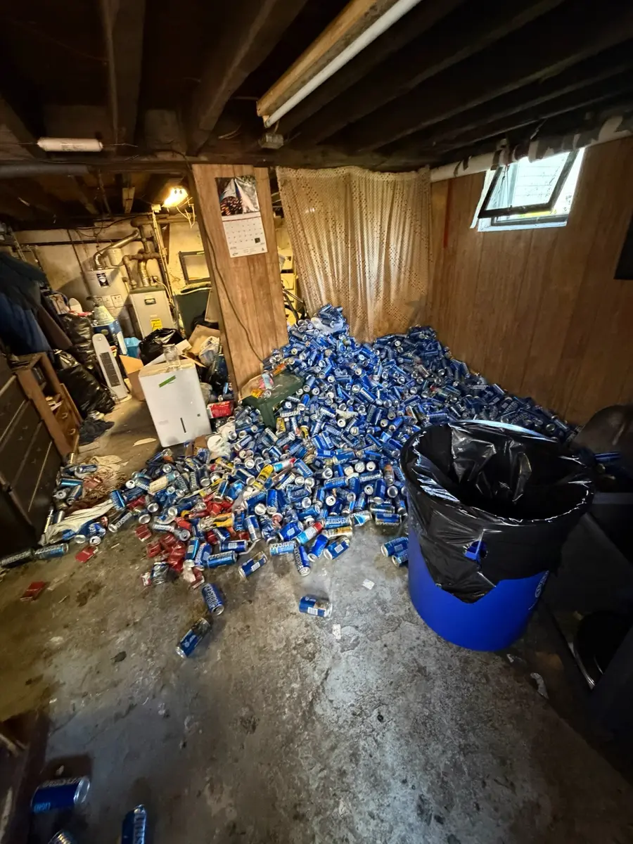 Large pile of cans being removed during the basement cleanout