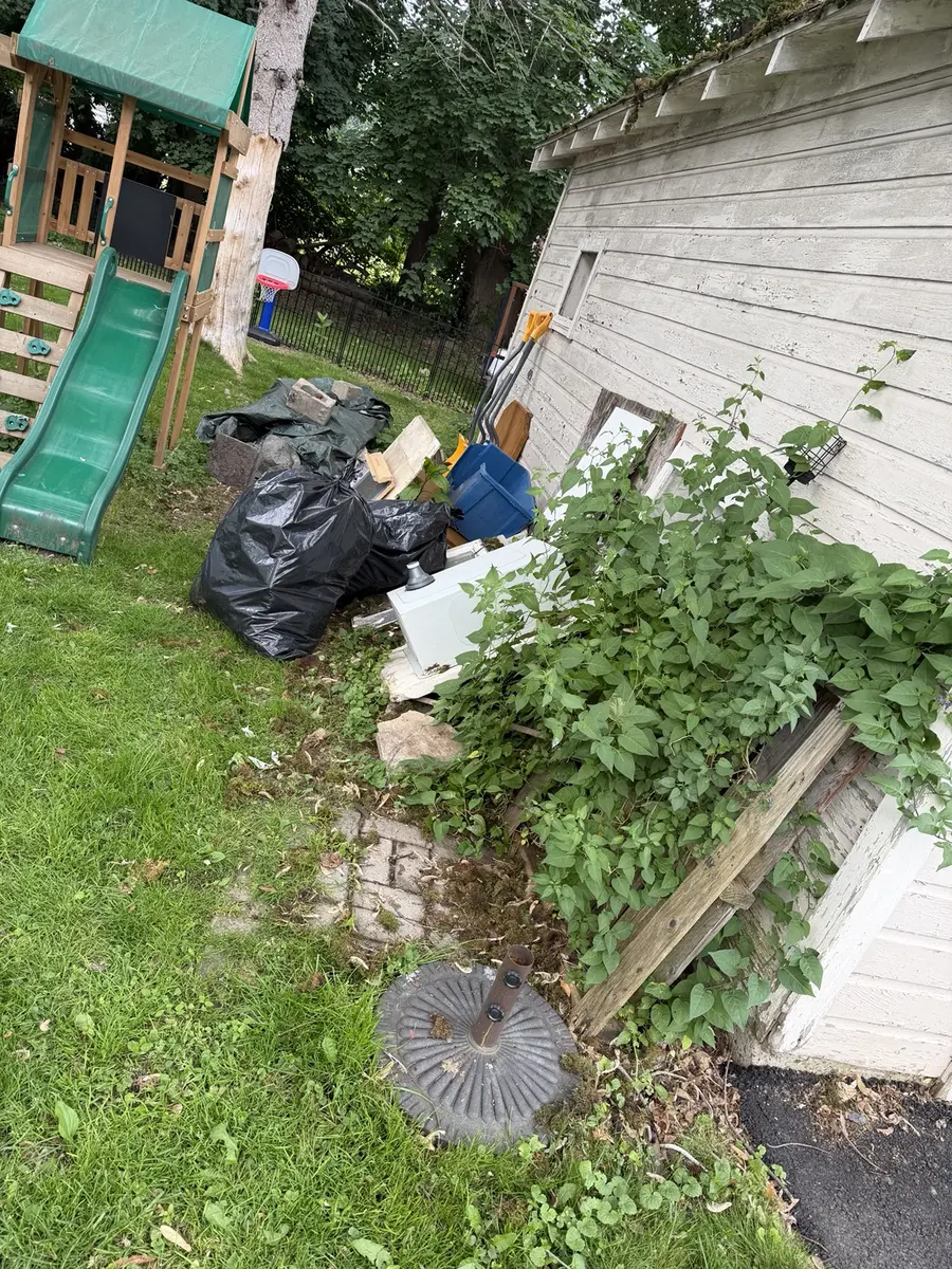 Bagged renovation debris staged outside for removal