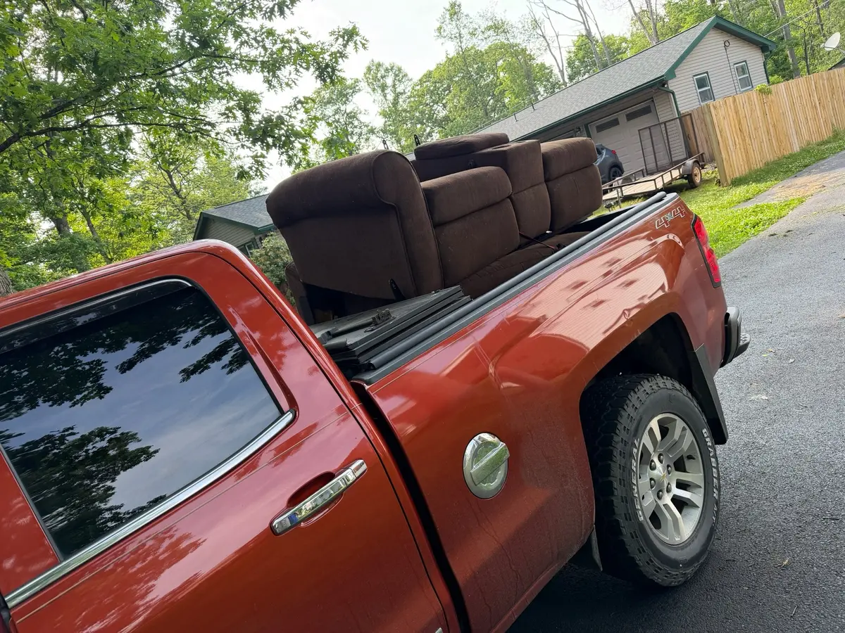 Brown couch loaded into Jay's red pickup truck