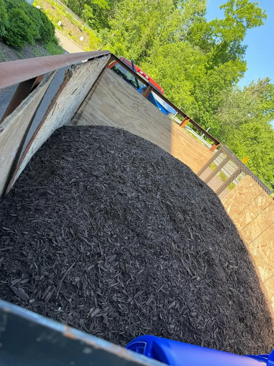 Fresh dark mulch ready for installation